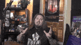 a man with long hair and a beard wearing a shirt that says be your own