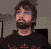 a man with a beard has a tattoo on his neck that reads inavoig