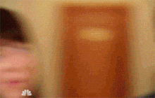 a blurry picture of a woman 's face with the letters nbc on the bottom right