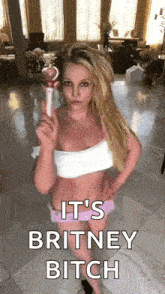 britney spears is holding a microphone in a living room .