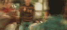 a blurry picture of a group of people talking to each other