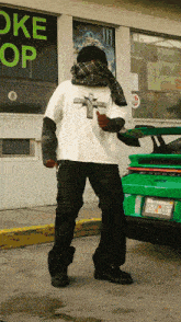 a man standing in front of a store that has the word oke on it