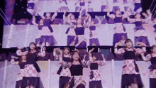 a group of young women are dancing on a stage