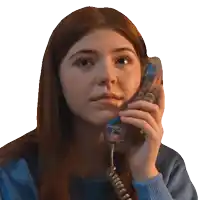 a woman in a blue shirt is talking on a telephone with a blue cord
