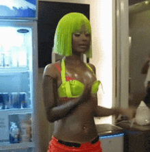 a woman in a neon green wig is standing in front of a fridge
