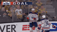 a hockey player with the number 36 on his jersey is celebrating a goal