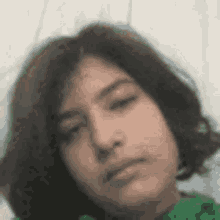 a close up of a young girl 's face with a serious look on her face .