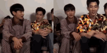 a group of young men are sitting next to each other and laughing .