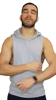 a man with a beard is wearing a gray tank top