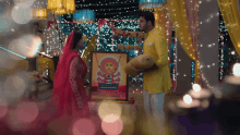 a man in a yellow suit is holding a stuffed animal while standing next to a woman