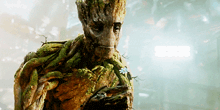 groot from guardians of the galaxy is holding a flower in his hand