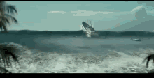 a ship is sinking in the ocean near a beach .