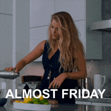 a woman pouring a drink in a kitchen with the words almost friday