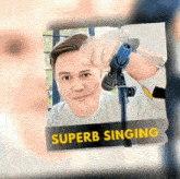a picture of a man holding a microphone with superb singing written on it