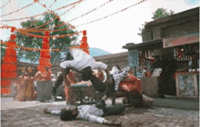 a man is doing a handstand while another man is laying on the ground in front of a store