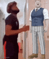 a man and a bear are standing next to each other in a hallway