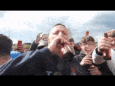 a man drinking from a bottle with the number 68 on his sweatshirt