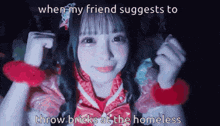 a girl in a pink dress is smiling while a friend suggests to throw bricks at a homeless person .