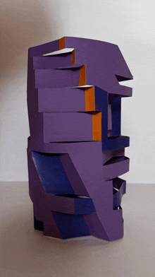 a purple and orange sculpture is stacked on top of itself
