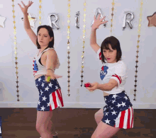 two women dancing in front of a sign that says ria r