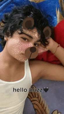 a young boy with a teddy bear mask on his face and the words hello huzz below him