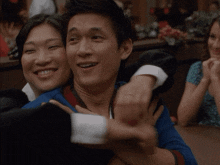 a man and a woman are hugging and smiling for the camera