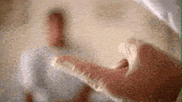 a close up of a person 's hand wearing gloves