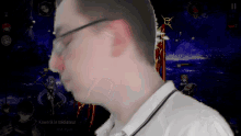 a man wearing glasses is looking at a screen that says kawerik le medateur