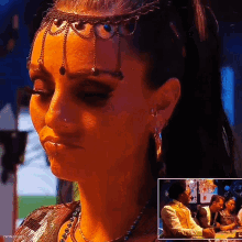 a woman is wearing a headpiece and earrings and has the word ivonne on the bottom right