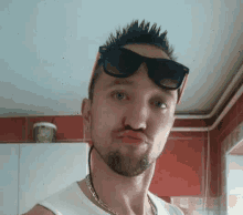 a man wearing sunglasses making a funny face