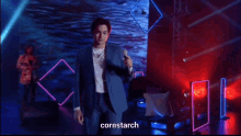 a man in a suit singing into a microphone with the word cornstarch on the bottom right