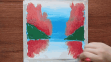 a person is painting a picture with a brush and tape