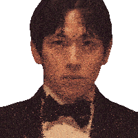 a man in a tuxedo with a bow tie looks at the camera