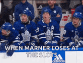 toronto maple leafs hockey players sitting on the bench