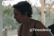 a woman in a black bra is standing in front of a sign that says tvresidence