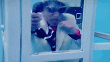a man in a suit and tie is taking a picture of himself