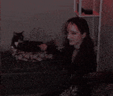 a woman sitting on a couch with a cat behind her and the words akzenith good one on the bottom right