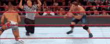 two men are wrestling in a ring with a referee in the background and the nextbigthing written in the corner