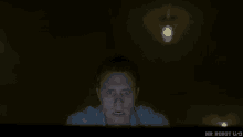 a man is looking at a computer screen with the words mr robot u-i on the bottom right
