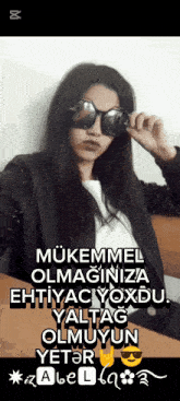 a woman wearing sunglasses and a black jacket with a caption that says mükemmel olmaginiza