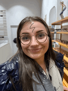 a woman wearing glasses has a lightning bolt drawn on her face