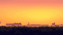 a sunset with a city in the distance and a field in the foreground