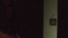 a shadow of a person is cast on a wall next to a sign that says ' i 'm sorry '