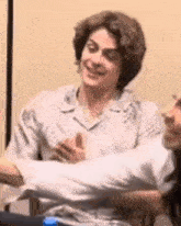 a man and a woman are sitting next to each other in a room .