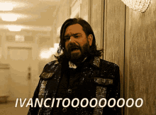 a man with long hair and a beard is wearing a sequined jacket and says ivancito000000