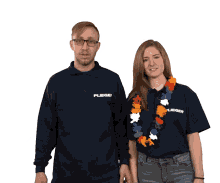 a man and a woman are posing for a picture and the woman is wearing a lei