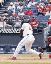 a baseball player with the number 4 on the back of his uniform