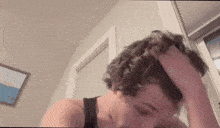 a person is holding their head in their hands while looking down .