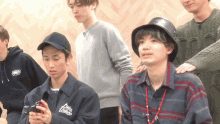 a group of young men including one wearing a jacket that says let 's play music