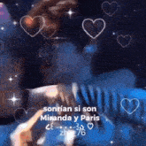 a man and a woman are kissing in a blurry photo with hearts and stars .